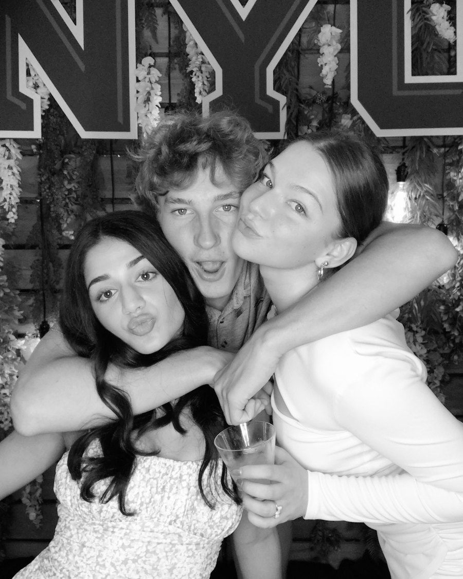 A black-and-white glam photo booth capture of guests