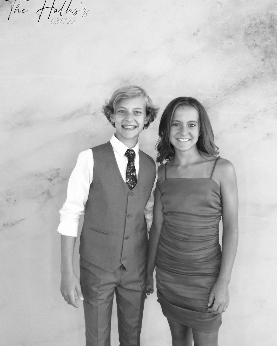 A glam black-and-white couple portrait on the marble backdrop