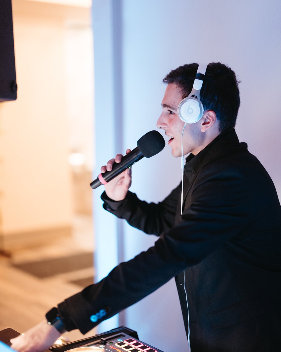 Primo today on the mic in headphones behind a professional DJ setup