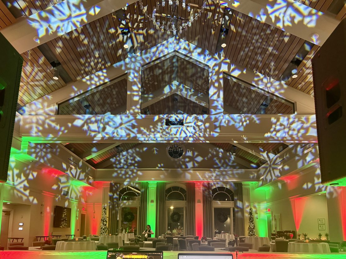 Venue washed in festive red and green up-lighting with snowflake projections